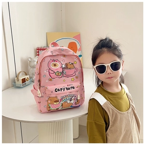 Close-up of pink kid backpack with cute capybara prints and front zipper pocket