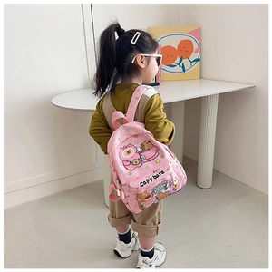 Pink Capybara cartoon backpack side view on young model in soft indoor setting