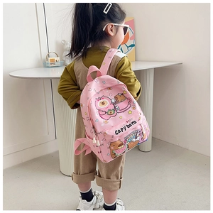 Pink kids backpack with cute capybara cartoon print shown on child model for size
