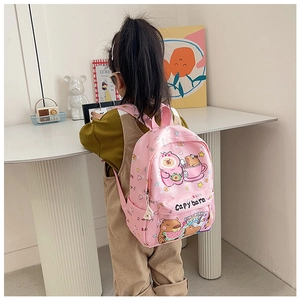 Detailed view of pink mini backpack featuring cute capybara prints and durable fabric
