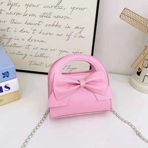 Detailed view of pink toddler mini bag with PU leather bow and silver chain strap