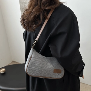 Vintage gray canvas crossbody bag with brown leather trim and adjustable shoulder strap