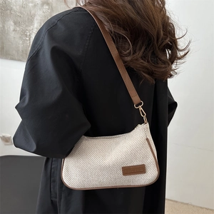 Retro woven cream shoulder bag with brown leather trim and golden metal hardware detail