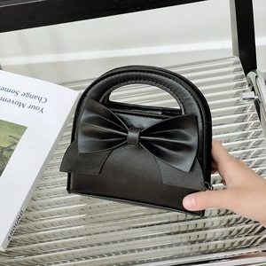 Cute black toddler handbag with oversized bow detail and top handle for girls