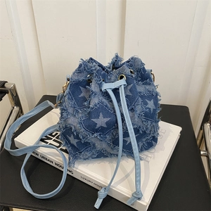 Denim blue bucket bag with star patterns and fringe details for women's crossbody wear