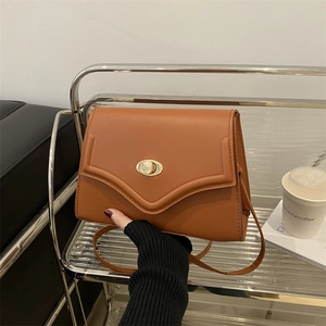 Chic brown minimalist leather shoulder bag with vintage gold swivel buckle clasp