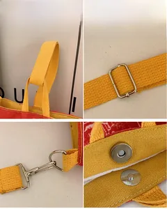 Detail der Segeltuchtasche mit verstellbarem gelbem Gurt, Metallhaken und Magnetverschluss
