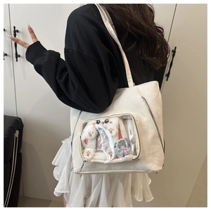 Close-up of cream PU leather ita bag showing a transparent window for plush toys