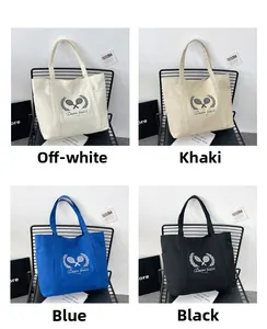 Detail showing the large canvas tote bag in four colors with Queen tennis print and side pocket