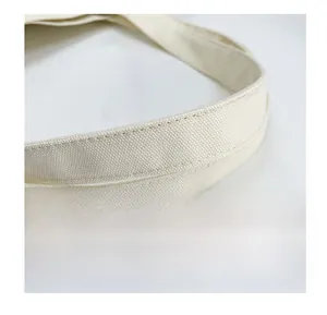 Close-up of high-density canvas tote with reinforced double stitching and natural texture