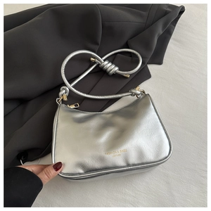 Macro view of silver metallic leather texture and fashion print on the hobo bag