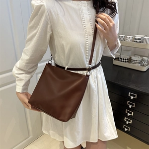 Minimalist dark brown tote bag crossbody style with smooth matte finish for daily commute
