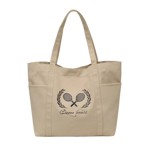 Minimalist beige canvas tote bag with Queen Tennis print and practical side pockets