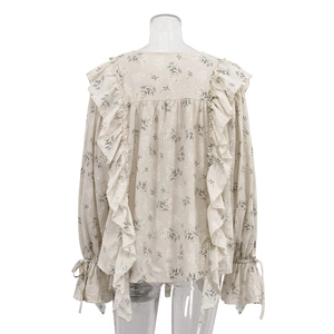 Detailed back view of a floral blouse featuring layered ruffles and adjustable tie cuffs