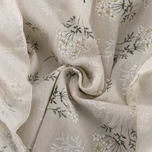 Close-up of floral ruffles and textured cotton gauze fabric on a French style blouse