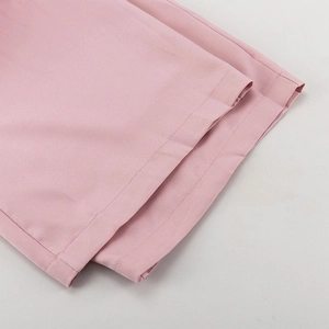 Detail der rosa Anzughose mit professionellem Doppelstich-Saum und feiner Stoffstruktur