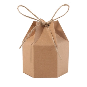 Detail of hexagonal kraft paper gift box with rustic twine bow and natural texture