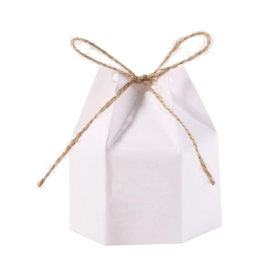 Macro detail of white hexagonal paper gift box with rustic brown hemp rope bow tie