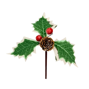 Detailed view of holly leaves with snow effect, pine cone and red berries picks