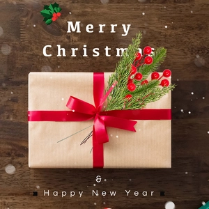 Top view of festive red berry and pine needle branches on a kraft gift box with red ribbon