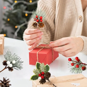 Close-up of DIY Christmas bouquet picks with snowy pine needles and red berries