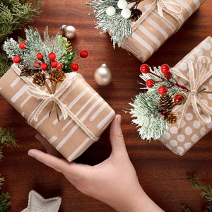 Close-up of Christmas berries and pine cones on a kraft paper gift box decoration