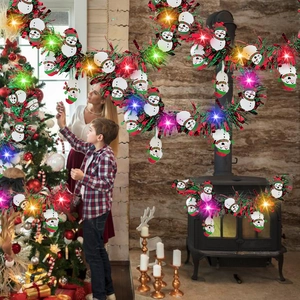 Red and green Christmas tinsel garland with snowman charms and LED lights for party decor