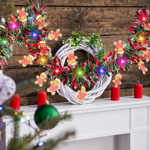 Close-up of LED Christmas tinsel garland with gingerbread men on a fireplace mantel