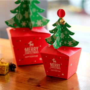 Christmas Eve red gift box with 3D green tree, golden bell, and reindeer patterns