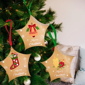 Star-shaped Christmas kraft paper gift boxes with festive patterns and hanging ribbons