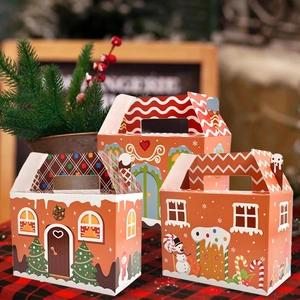 Three gingerbread house Christmas gift boxes with handles and festive winter patterns