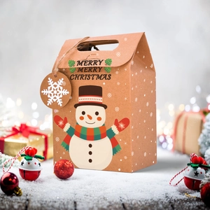 Detail of Christmas snowman kraft paper gift box with snowflake tag in snowy scene