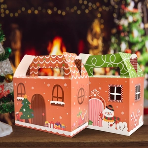 Christmas gingerbread house paper gift boxes with snowman and tree on wooden table