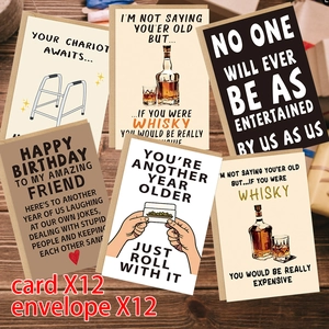Set of 12 funny birthday cards with whiskey humor and envelopes on a dark wood background