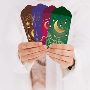 Detail of Eid Mubarak envelopes with moon and lantern patterns in four rich colors