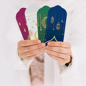 Detail of four colorful Eid Mubarak envelopes with gold foil moon and lantern patterns