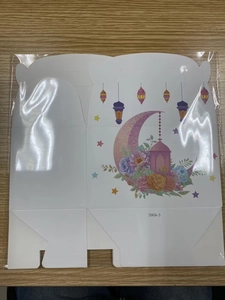 Detail of Ramadan themed gift box with moon and lantern prints on white cardboard