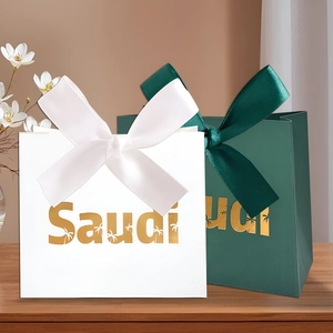 Macro detail of Saudi palm tree gift bags with gold lettering and decorative bows