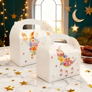 Macro detail of Eid theme gift boxes in two sizes with gold moon and floral prints