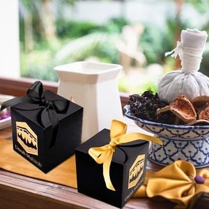 Detail of Umrah Mubarak black gift boxes with gold Kaaba foil and satin ribbons