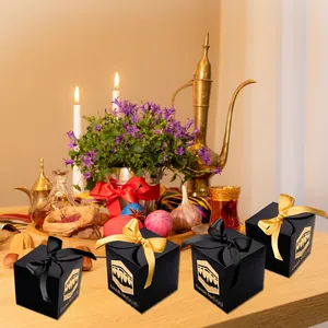 Black Umrah Mubarak gift boxes with gold Kaaba pattern and satin ribbons for celebrations