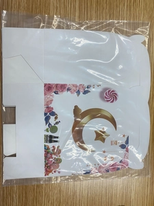 Flat lay view of cardboard gift box template with golden stars and floral patterns