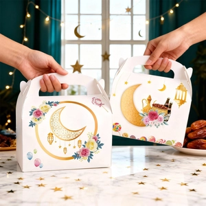 White Eid Mubarak gift boxes with gold moon and floral patterns for party candies