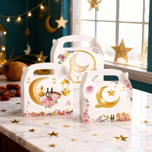 Three Ramadan themed gift boxes with golden moon and floral patterns on white cardstock