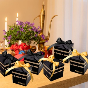 Elegant black gift box set with gold foil patterns and satin ribbons for holiday gifts