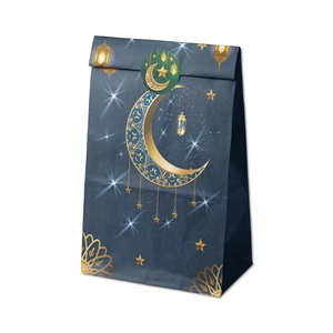 Macro view of blue Ramadan gift paper bag with gold moon star patterns and sealing sticker