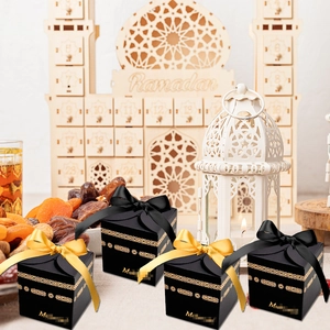 Detail of Ramadan gift boxes with gold foil Kaaba patterns and Mubarak greetings