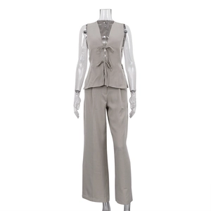 Close-up of gray two-piece set featuring a bow-tie vest and high-waist wide-leg trousers