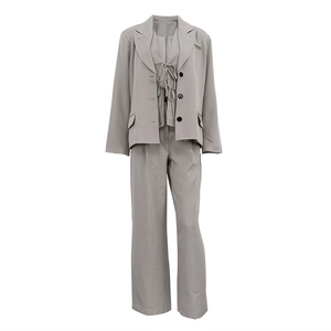 Detailed close-up of grey three-piece suit featuring lace-up vest and wide-leg pants