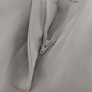 Close-up of high-quality gray suit trousers featuring a smooth zipper and refined fabric texture